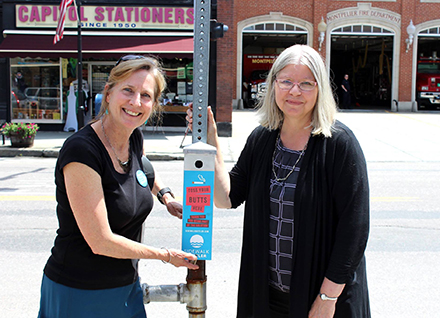 two women, cigarette disposal stand