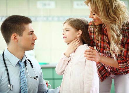 child holding throat