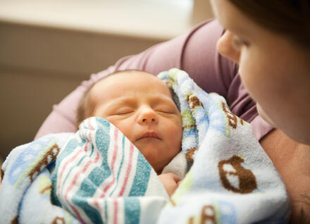 Mom holding newborn infant Mom holding newborn infant