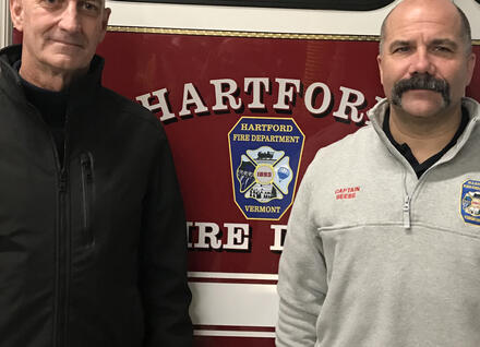 two people infront of Hartford fire truck