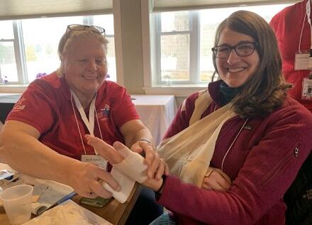 two people practicing bandaging two people practicing bandaging