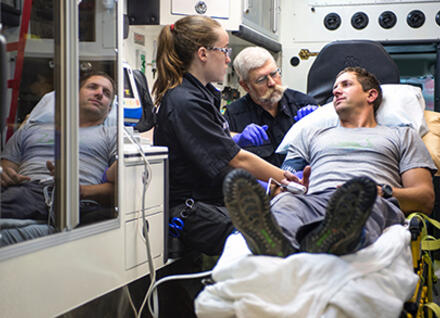 Vermont EMS responders with patient and ambulance Vermont EMS responders with patient and ambulance
