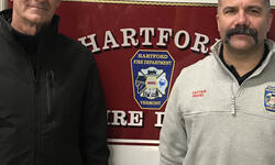 two people infront of Hartford fire truck