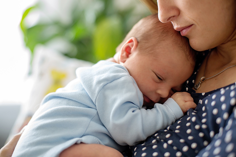 Baby being held by a caregiver