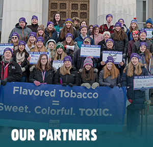 A group of Vermont high school students stands on the statehouse steps to rally against flavored tobacco