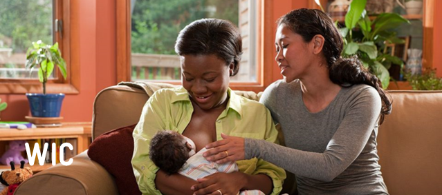 WIC, two adults sitting on a couch holding a baby