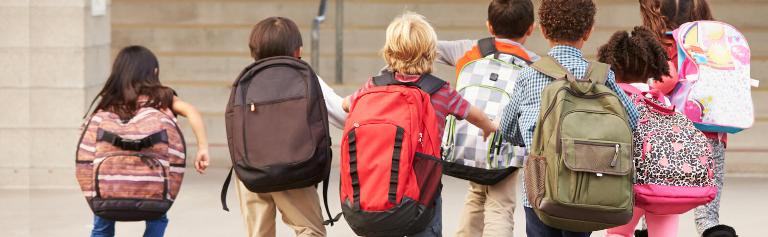 Kids with backpacks running