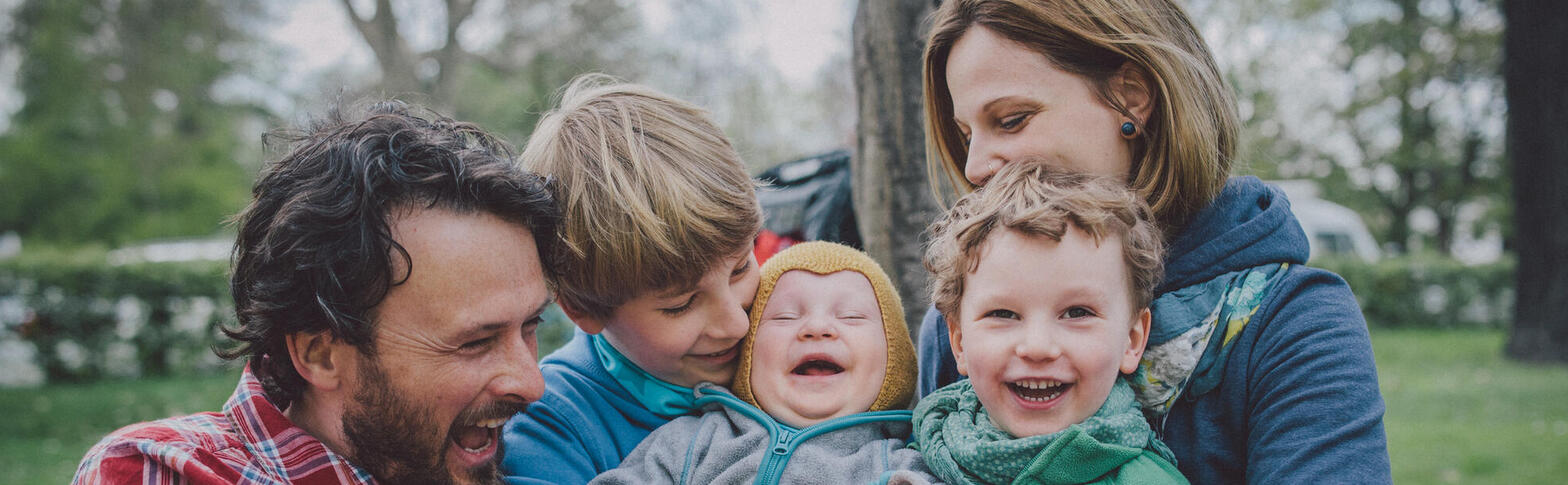 Mother, father, three young children outdoors