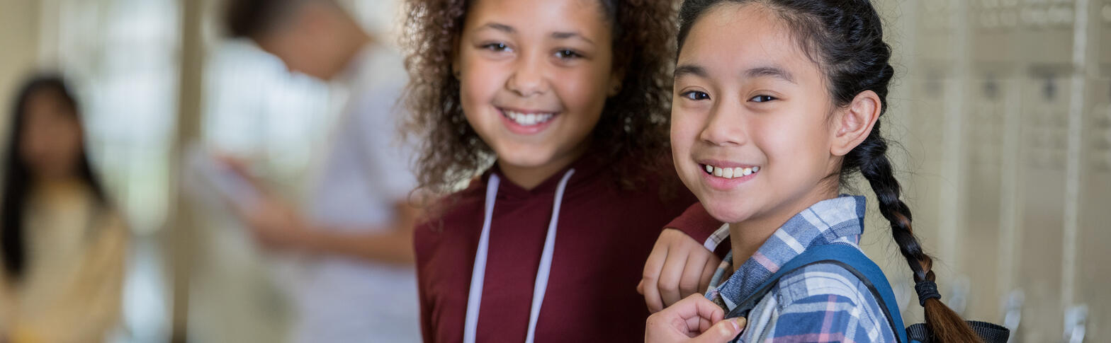 two middle school students by lockers