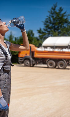 worker drinking water on hot day