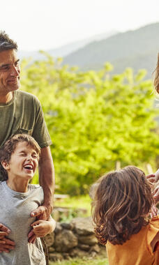 Mother, father, two young children and a baby outdoors