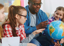 teacher with students and globe teacher with students and globe