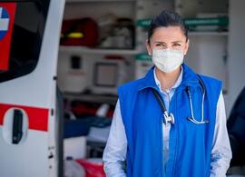 first responder in front of emergency vehicle