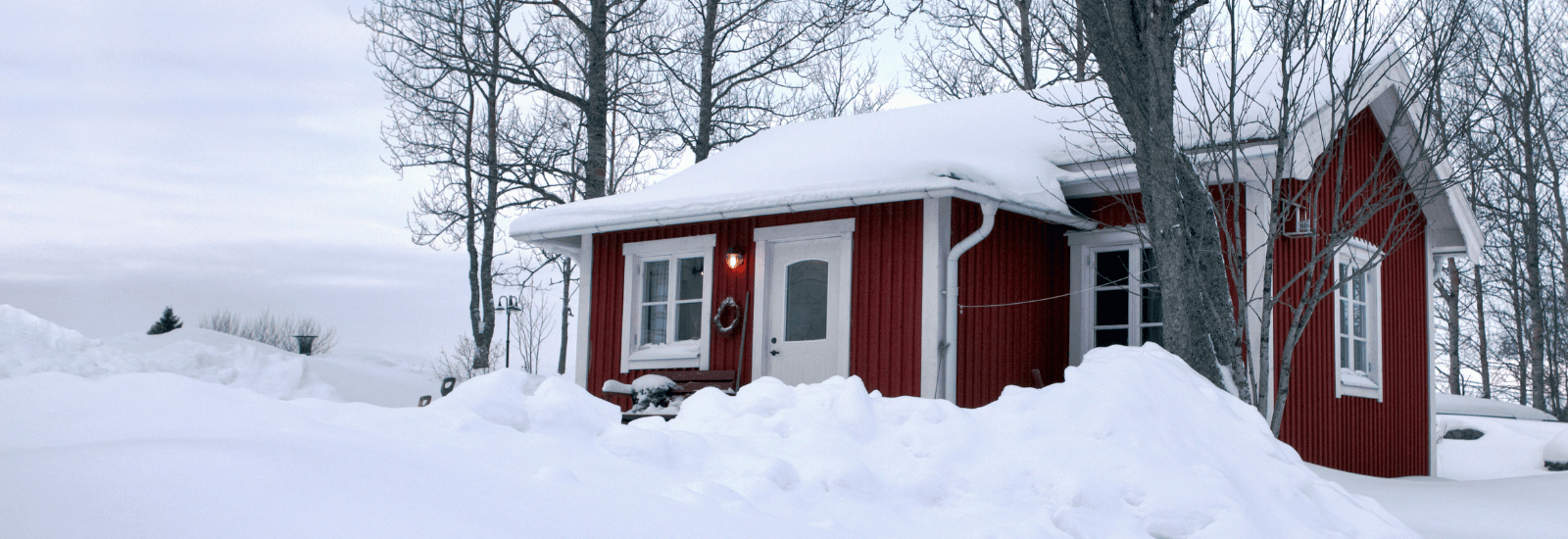 Red house covered in snow.