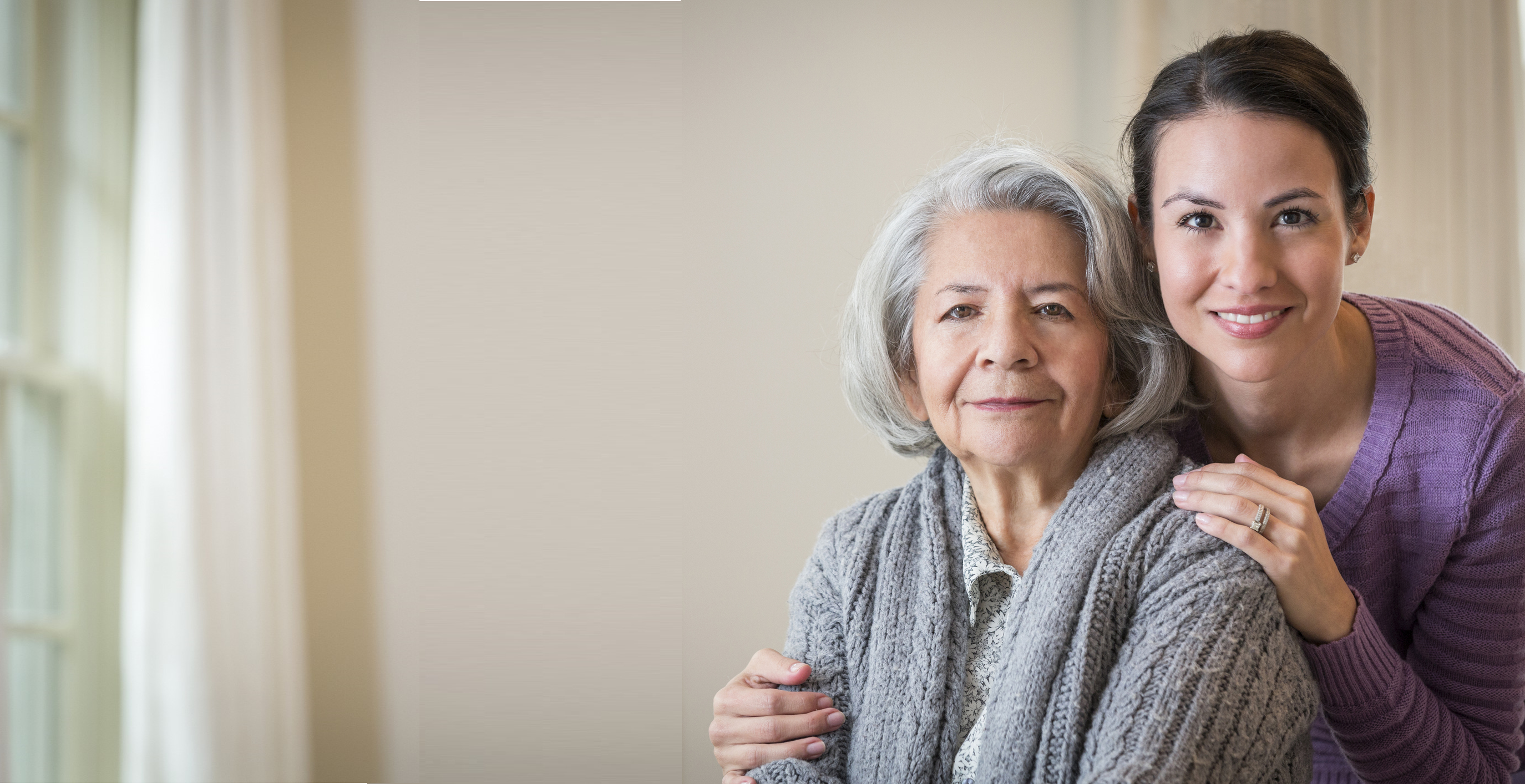 Daughter hugging her mom and smiling.