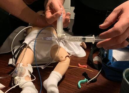 EMS providers practicing skills on pediatric mannequin