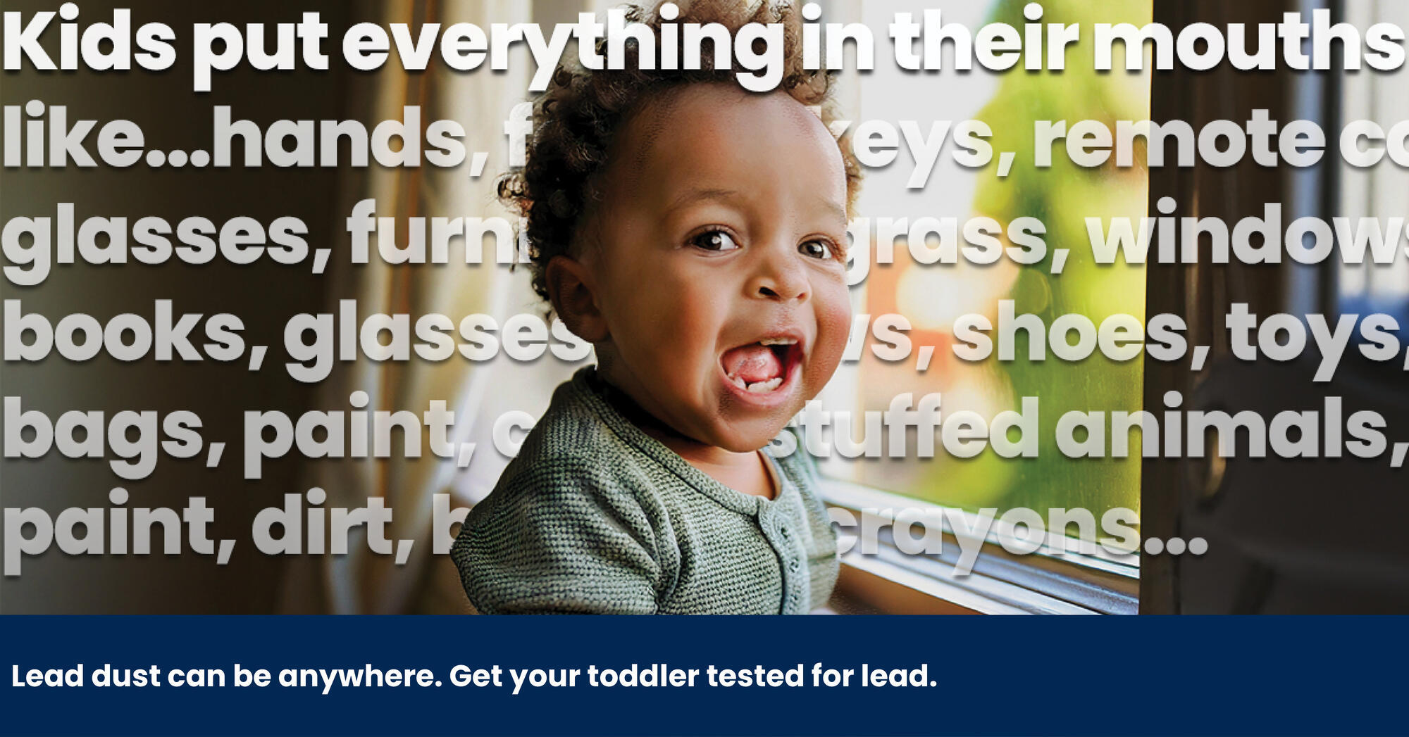 toddler smiling at a windowsill