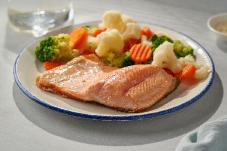 cooked fish with vegetables on a plate