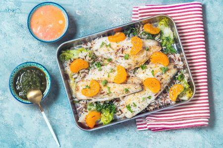 baked fish with fruit and vegetables in a pan