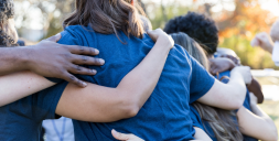 Backs of people arm and arm