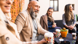 bearded man having coffee with friends