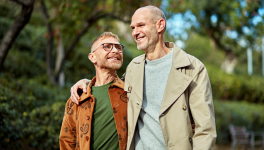Two men smiling with their arms around each other's shulders