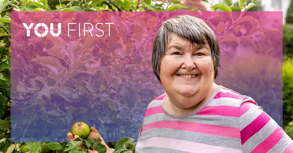 Woman smiling while apple picking