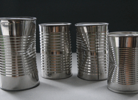 Three dented cans cans