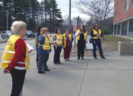 People outdoors wearing emergency vests
