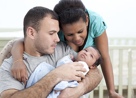 New Parents Couple holding infant