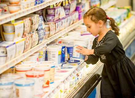 girl choosing yogurt
