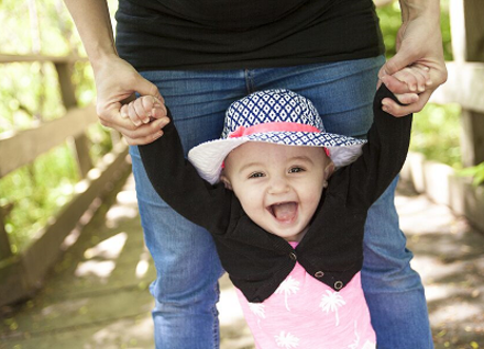 Help Me Grow Vermont small baby walking with help of an adult