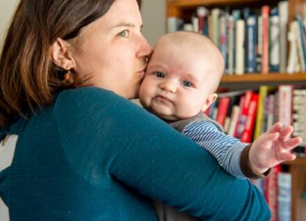 woman kissing baby