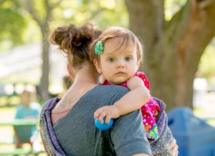woman carrying child
