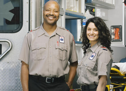 two paramedics outside ambulance