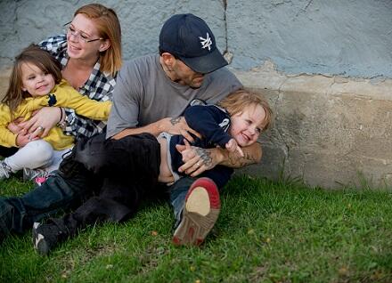 family sitting on the ground