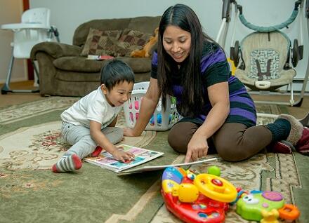 woman and boy looking at book