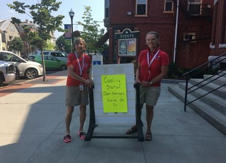 two volunteers outside public building two volunteers outside public building