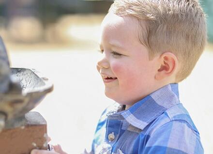 boy drinking at outdoor fountain boy drinking at outdoor fountain