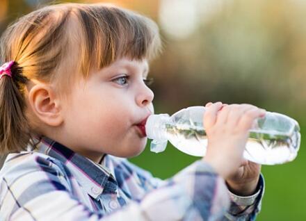 girl drinking from water bottle