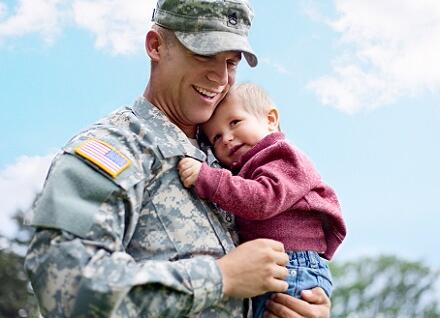 man in uniform holding baby