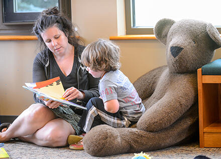 child care provider reading to child