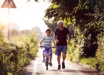 boy biking with man running boy biking with man running