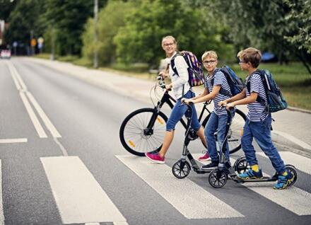 kids on scooters crossing road kids on scooters crossing road