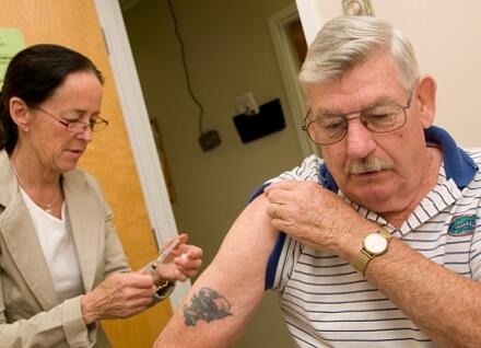 nurse giving man a vaccine