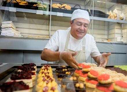 baker with cupcakes man baking cupcakes
