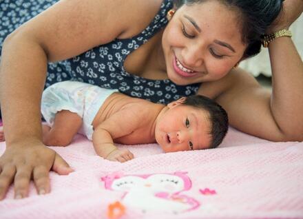 smiling mother with new baby