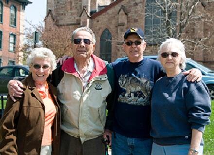 four people smiling