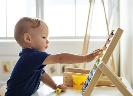 toddler with abacus