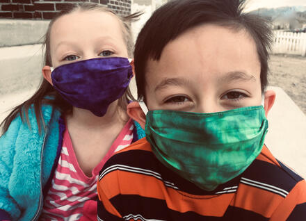 2 children wearing cloth masks